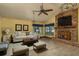 Comfortable living room with a brick fireplace and a ceiling fan at 14449 Wadsworth Dr, Odessa, FL 33556
