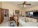 Comfortable bedroom featuring a ceiling fan, sitting area, and access to the outdoors at 14449 Wadsworth Dr, Odessa, FL 33556