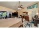 Spacious bedroom features a ceiling fan, large window, and access to a private outdoor area at 14449 Wadsworth Dr, Odessa, FL 33556