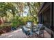 Charming patio with outdoor seating, lush plants, and a hot tub, perfect for relaxing and entertaining at 14449 Wadsworth Dr, Odessa, FL 33556
