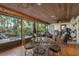 Expansive covered patio with multiple seating areas and views of the landscaped yard at 14449 Wadsworth Dr, Odessa, FL 33556