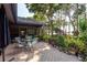 Outdoor patio overlooking a serene lake, complete with stylish seating and lush landscaping for peaceful enjoyment at 14449 Wadsworth Dr, Odessa, FL 33556