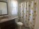 Bathroom features a vanity and sunflower print shower curtain at 1602 Taylor Lake Cir, Largo, FL 33778