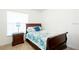 This bedroom features a single bed, lamp and a nightstand, with natural lighting at 1602 Taylor Lake Cir, Largo, FL 33778