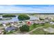 Overhead shot of a cozy house nestled within a lakeside residential area at 1609 Pebble Beach N Blvd, Sun City Center, FL 33573