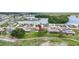 A scenic aerial view showcases a charming home near a serene lake community at 1609 Pebble Beach N Blvd, Sun City Center, FL 33573