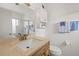 Bathroom featuring a wood vanity, a large mirror, a shower and toilet, and a cabinet for plenty of storage at 1609 Pebble Beach N Blvd, Sun City Center, FL 33573