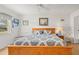 Comfortable bedroom featuring a ceiling fan, a large wooden bed, a window, and a white bench at 1609 Pebble Beach N Blvd, Sun City Center, FL 33573