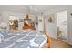 Bedroom leading to a dining room and bathroom, decorated with sailboat-themed wall decor and a wooden dresser at 1609 Pebble Beach N Blvd, Sun City Center, FL 33573