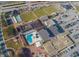 Aerial view of community amenities including pool, tennis, lawn bowling, and clubhouse at 1609 Pebble Beach N Blvd, Sun City Center, FL 33573