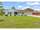 A charming single-story home featuring a well-kept lawn and an attached two-car garage at 1609 Pebble Beach N Blvd, Sun City Center, FL 33573