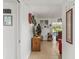 Hallway leads to a sunlit living room with tiled floors and charming decor at 1609 Pebble Beach N Blvd, Sun City Center, FL 33573