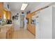 Well-lit kitchen featuring tile flooring and white appliances at 1609 Pebble Beach N Blvd, Sun City Center, FL 33573