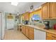 Bright kitchen with light wood cabinets, tile floors, and breakfast nook at 1609 Pebble Beach N Blvd, Sun City Center, FL 33573