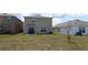 A backyard with a view of the home's exterior, landscaping and a tree at 16728 Kingman Reef St, Wimauma, FL 33598