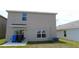 A view of the backyard showcasing the home's rear exterior and the patio at 16728 Kingman Reef St, Wimauma, FL 33598