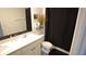 Modern bathroom features a dual-sink vanity with stylish black hardware and contemporary decor at 16728 Kingman Reef St, Wimauma, FL 33598