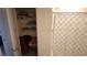 This bathroom features a shower, shelving, and a peek into an adjacent bedroom at 16728 Kingman Reef St, Wimauma, FL 33598