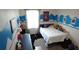 Youthful bedroom featuring modern decor, ample natural light, and a functional layout for study and rest at 16728 Kingman Reef St, Wimauma, FL 33598