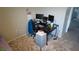 Functional home office setup with a large desk, multiple monitors, and convenient storage solutions at 16728 Kingman Reef St, Wimauma, FL 33598
