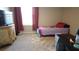 Cozy bedroom featuring a comfortable twin bed, dresser with TV and a modern desk area at 16728 Kingman Reef St, Wimauma, FL 33598