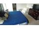 This bedroom is decorated with a comfy chair, soft pillows, and dark-stained wood dresser at 16728 Kingman Reef St, Wimauma, FL 33598
