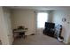 Versatile bonus room with a TV, a piano, and natural light offers flexible living space at 16728 Kingman Reef St, Wimauma, FL 33598