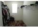 A walk-in closet with ample storage racks, a window and colorful rug provides style and convenience at 16728 Kingman Reef St, Wimauma, FL 33598