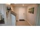 Welcoming entrance featuring a staircase, neutral paint, tiled floors, and decorative wall art at 16728 Kingman Reef St, Wimauma, FL 33598