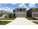 Charming two-story home with a well-manicured lawn and a spacious two-car garage at 16728 Kingman Reef St, Wimauma, FL 33598