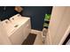 Well-equipped laundry area with modern white washer and dryer, shelving, and a convenient laundry basket at 16728 Kingman Reef St, Wimauma, FL 33598
