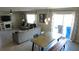 Open-concept living and dining area features neutral decor, modern lighting, and seamless indoor-outdoor flow at 16728 Kingman Reef St, Wimauma, FL 33598