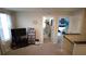 Inviting upstairs landing featuring a TV with gaming console and open doorways to multiple rooms at 16728 Kingman Reef St, Wimauma, FL 33598