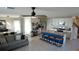 Bright open-concept living area with a kitchen island, dining table, and comfortable sofa at 16728 Kingman Reef St, Wimauma, FL 33598