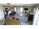 Spacious open-concept area featuring an island kitchen, dining table, and living room setup at 16728 Kingman Reef St, Wimauma, FL 33598