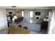 Spacious open-concept area with an island kitchen, dining table, and living room setup at 16728 Kingman Reef St, Wimauma, FL 33598