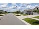 Quiet residential street featuring well-maintained homes, sidewalks, and lush landscaping at 16728 Kingman Reef St, Wimauma, FL 33598