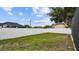 A large, mostly empty backyard surrounded by a tall, white, privacy fence and a few trees at 1675 Eden Ct, Clearwater, FL 33756