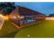 Backyard area enclosed with a pool, mini golf area, and seating at 1675 Eden Ct, Clearwater, FL 33756