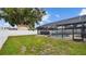 A backyard with an enclosed swimming pool, a hot tub, and a white privacy fence at 1675 Eden Ct, Clearwater, FL 33756