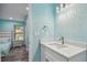 Bathroom featuring sleek white vanity, quartz countertop, and modern fixtures at 1675 Eden Ct, Clearwater, FL 33756