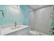 Contemporary bathroom featuring sleek white vanity, quartz countertop, and stylish shower with patterned tile at 1675 Eden Ct, Clearwater, FL 33756