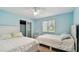 Bright bedroom featuring two beds, a ceiling fan, and a closet, offering comfortable living space at 1675 Eden Ct, Clearwater, FL 33756