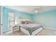 Bright bedroom features carpet, large window with blinds, and minimalist nightstands with lamps on each side of the bed at 1675 Eden Ct, Clearwater, FL 33756