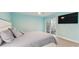 A well-lit bedroom with sliding glass doors, a television, and a king sized bed featuring an upholstered headboard at 1675 Eden Ct, Clearwater, FL 33756