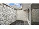 Unique courtyard featuring stone walls, rock ground covering, and access door to the interior space at 1675 Eden Ct, Clearwater, FL 33756