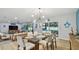 Bright dining area with glass table, modern lighting, and access to the pool at 1675 Eden Ct, Clearwater, FL 33756