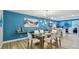 Dining area showcasing a glass table, modern lighting, and coastal-inspired decor at 1675 Eden Ct, Clearwater, FL 33756