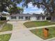 Charming single-story home featuring well-maintained landscaping, a circular driveway, and classic architectural details at 1675 Eden Ct, Clearwater, FL 33756