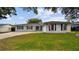 Charming one-story home with a well-maintained lawn and a classic American flag displayed at 1675 Eden Ct, Clearwater, FL 33756